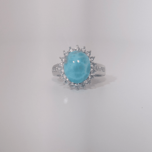 Women's Sterling Silver Ring with oval blue Larimar center stone, accented by round Cubic Zirconia in halo and band setting.