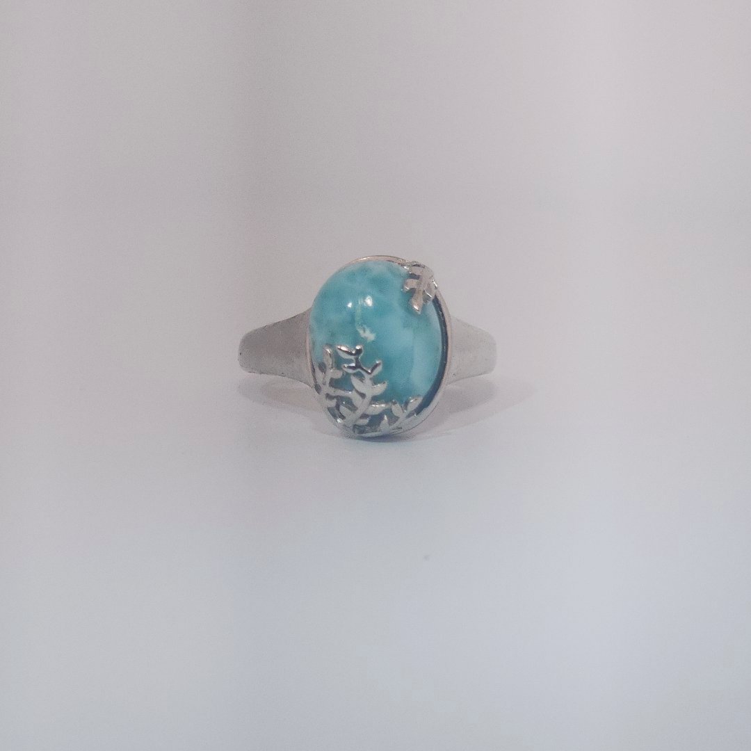 Women’s ring with oval Larimar cabochon in 9 sterling silver featuring a delicate branch motif.