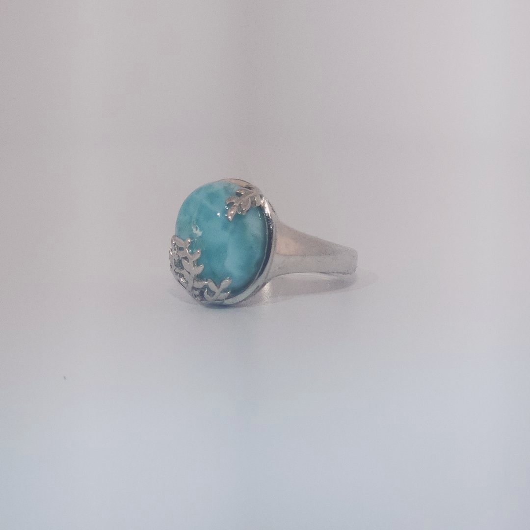 Women’s ring with oval Larimar cabochon in 9 sterling silver featuring a delicate branch motif.