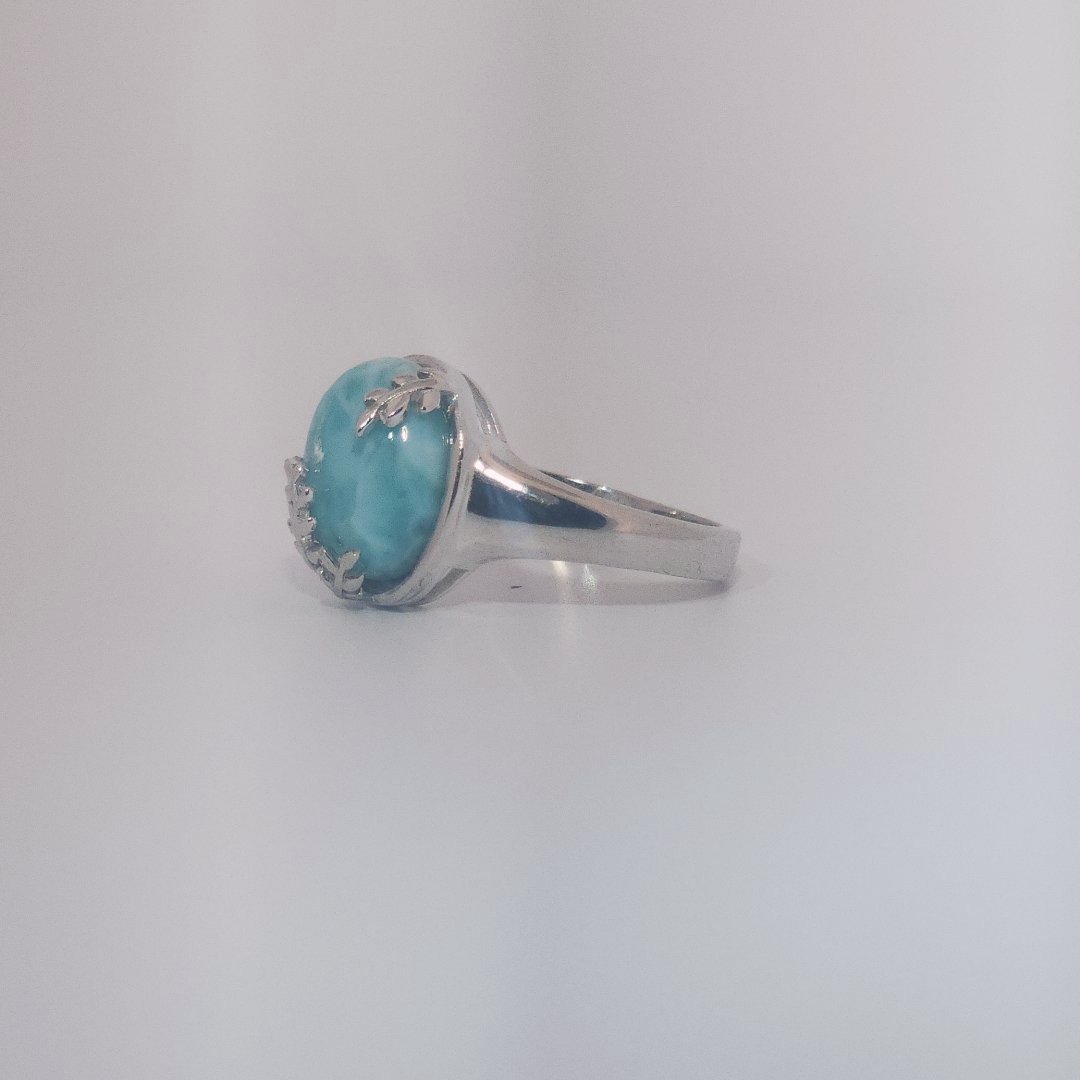 Women’s ring with oval Larimar cabochon in 9 sterling silver featuring a delicate branch motif.