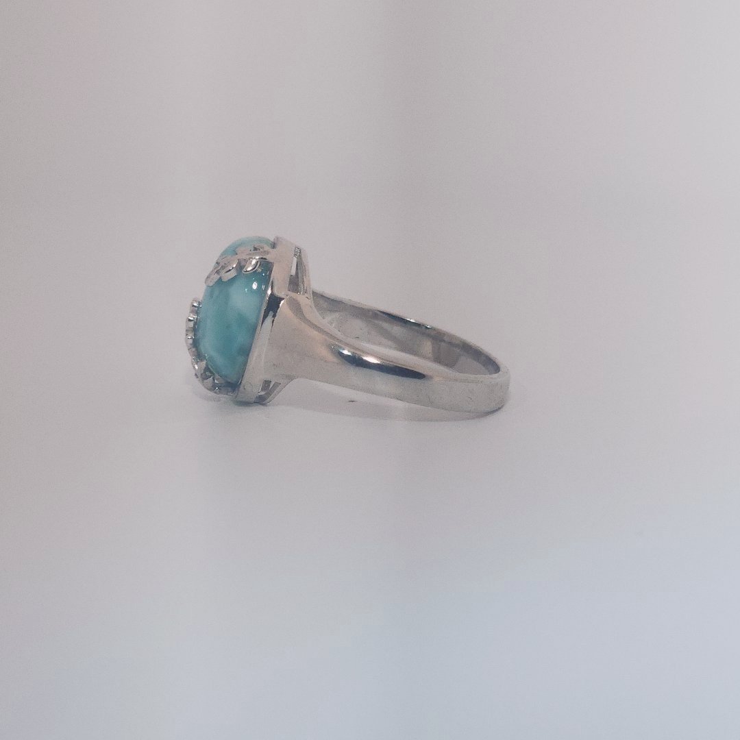Women’s ring with oval Larimar cabochon in 9 sterling silver featuring a delicate branch motif.