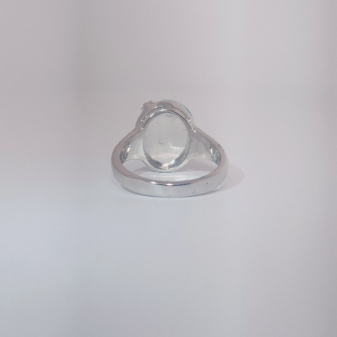 Women’s ring with oval Larimar cabochon in 9 sterling silver featuring a delicate branch motif.