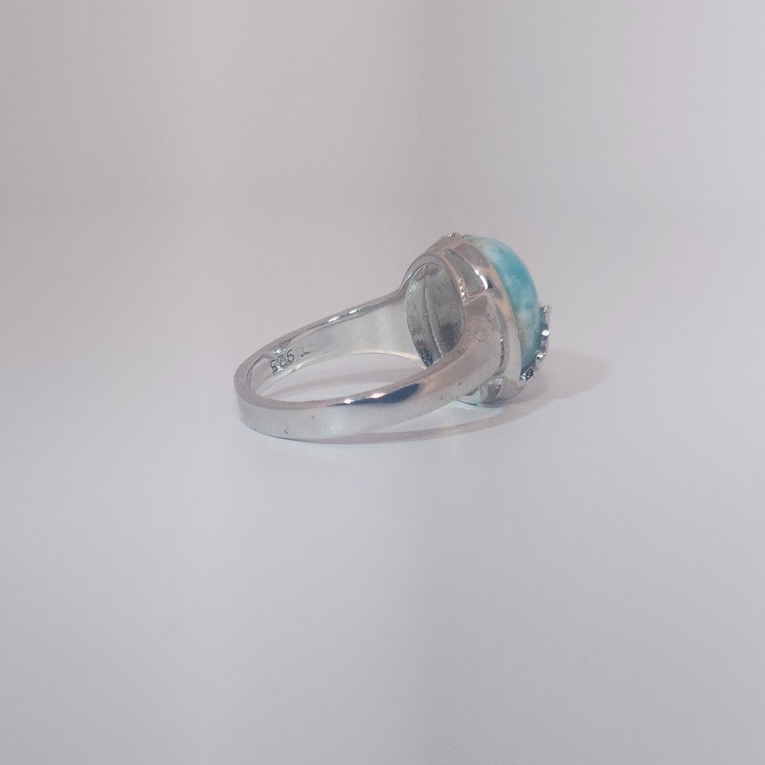 Women’s ring with oval Larimar cabochon in 9 sterling silver featuring a delicate branch motif.