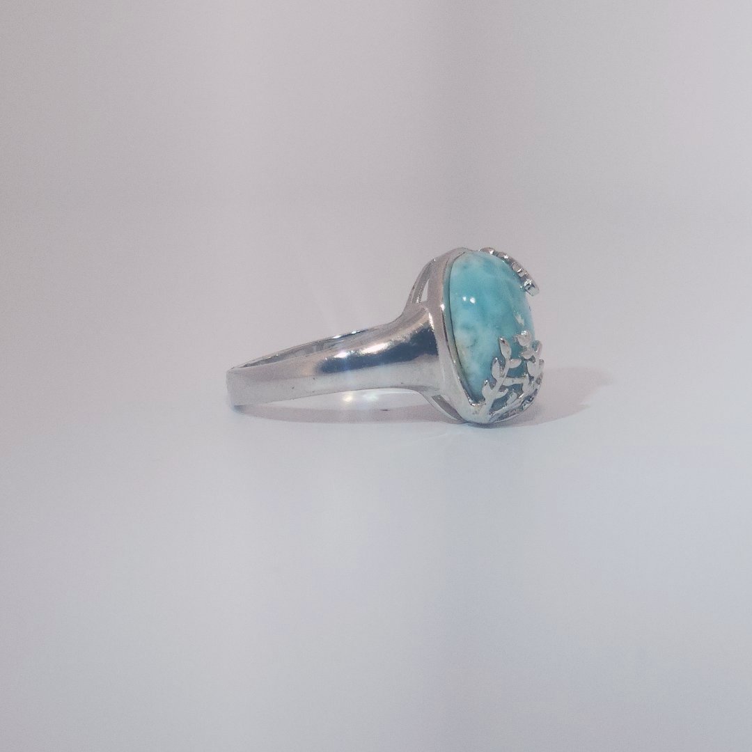 Women’s ring with oval Larimar cabochon in 9 sterling silver featuring a delicate branch motif.