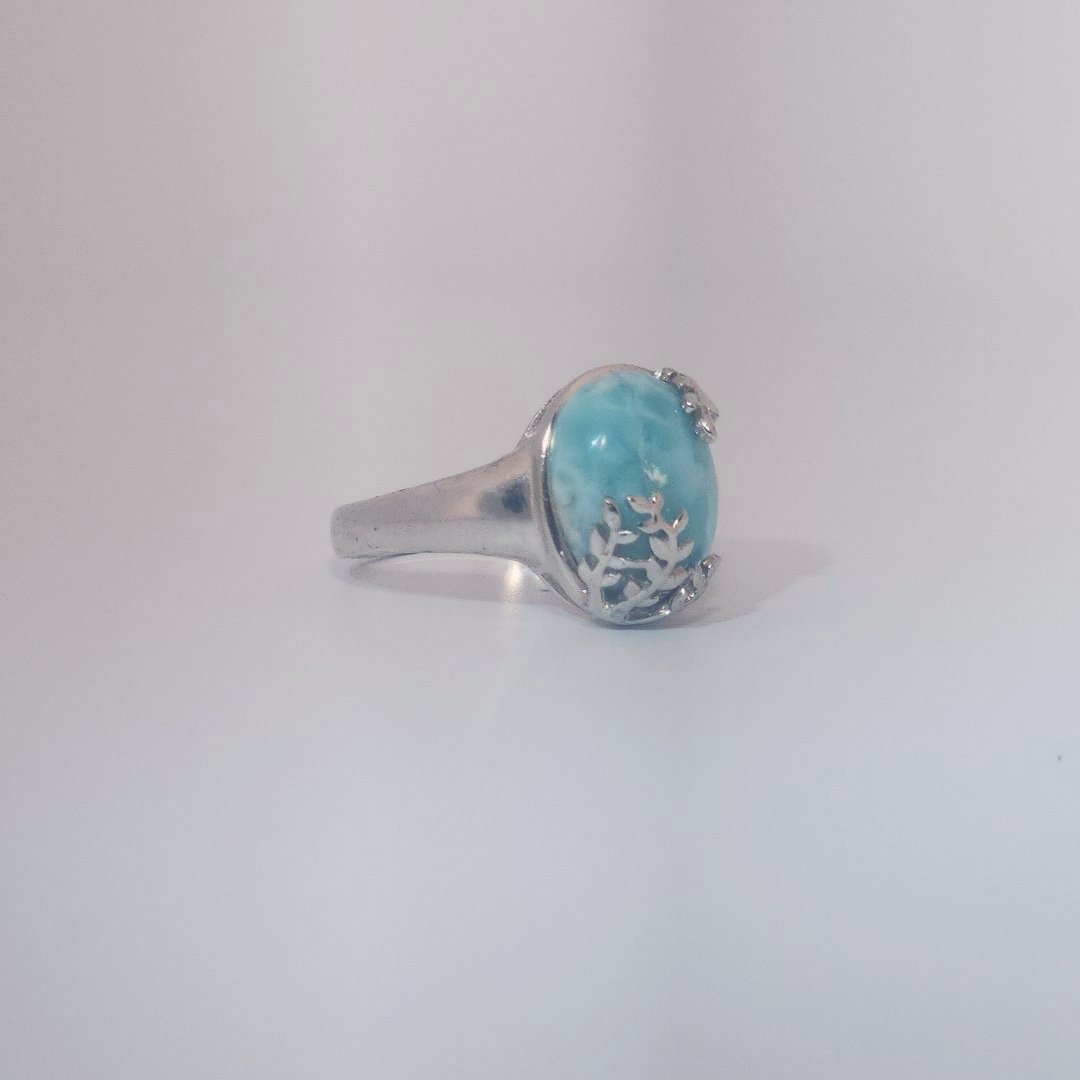 Women’s ring with oval Larimar cabochon in 9 sterling silver featuring a delicate branch motif.