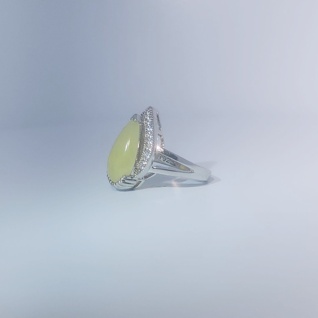 Women's Teardrop Ring in 925 Sterling Silver featuring a pear-shaped yellow-green Jade center stone accentuated by a delicate halo of small, bright stones.