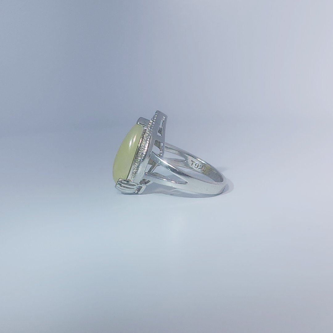 Women's Teardrop Ring in 925 Sterling Silver featuring a pear-shaped yellow-green Jade center stone accentuated by a delicate halo of small, bright stones.