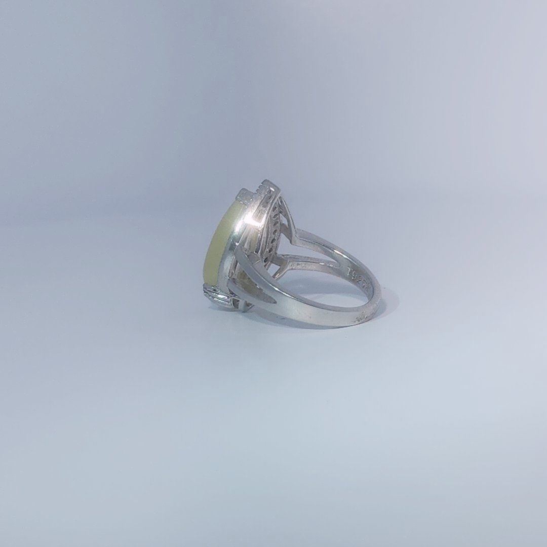 Women's Teardrop Ring in 925 Sterling Silver featuring a pear-shaped yellow-green Jade center stone accentuated by a delicate halo of small, bright stones.