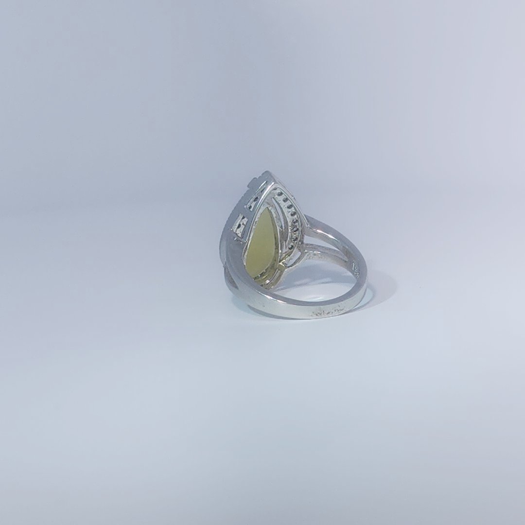 Women's Teardrop Ring in 925 Sterling Silver featuring a pear-shaped yellow-green Jade center stone accentuated by a delicate halo of small, bright stones.