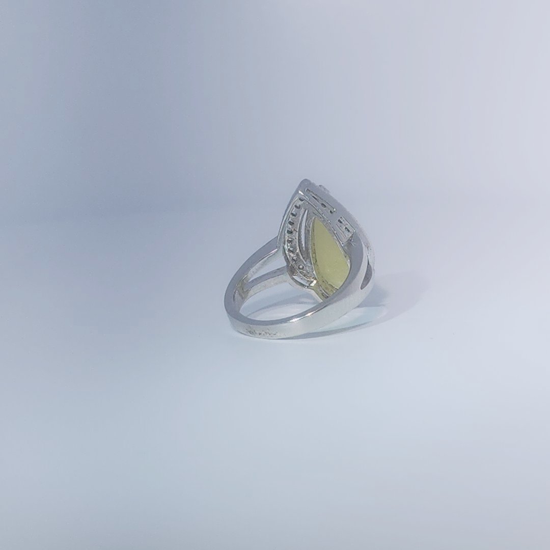 Women's Teardrop Ring in 925 Sterling Silver featuring a pear-shaped yellow-green Jade center stone accentuated by a delicate halo of small, bright stones.