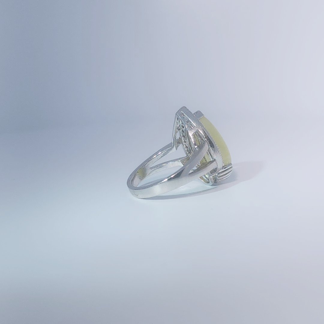 Women's Teardrop Ring in 925 Sterling Silver featuring a pear-shaped yellow-green Jade center stone accentuated by a delicate halo of small, bright stones.