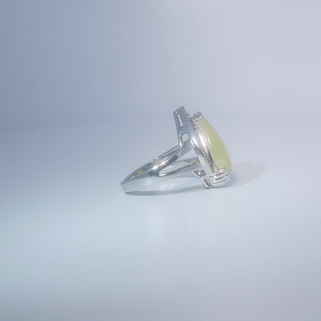 Women's Teardrop Ring in 925 Sterling Silver featuring a pear-shaped yellow-green Jade center stone accentuated by a delicate halo of small, bright stones.