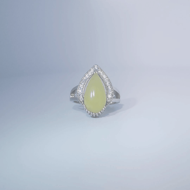 Women's Teardrop Ring in 925 Sterling Silver featuring a pear-shaped yellow-green Jade center stone accentuated by a delicate halo of small, bright stones.