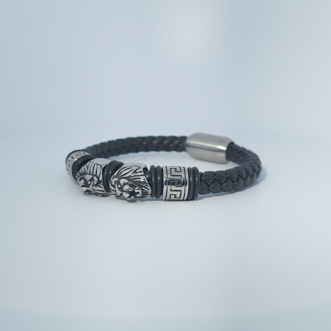 Black braided leather bracelet with stainless steel lion head and decorative tube accents, magnetic clasp, male style.