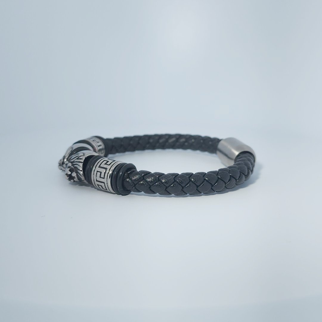 Black braided leather bracelet with stainless steel lion head and decorative tube accents, magnetic clasp, male style.
