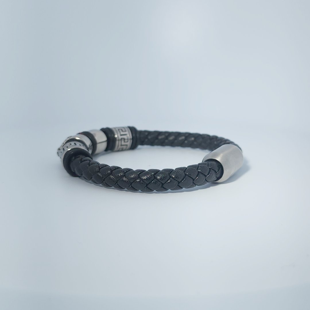 Black braided leather bracelet with stainless steel lion head and decorative tube accents, magnetic clasp, male style.