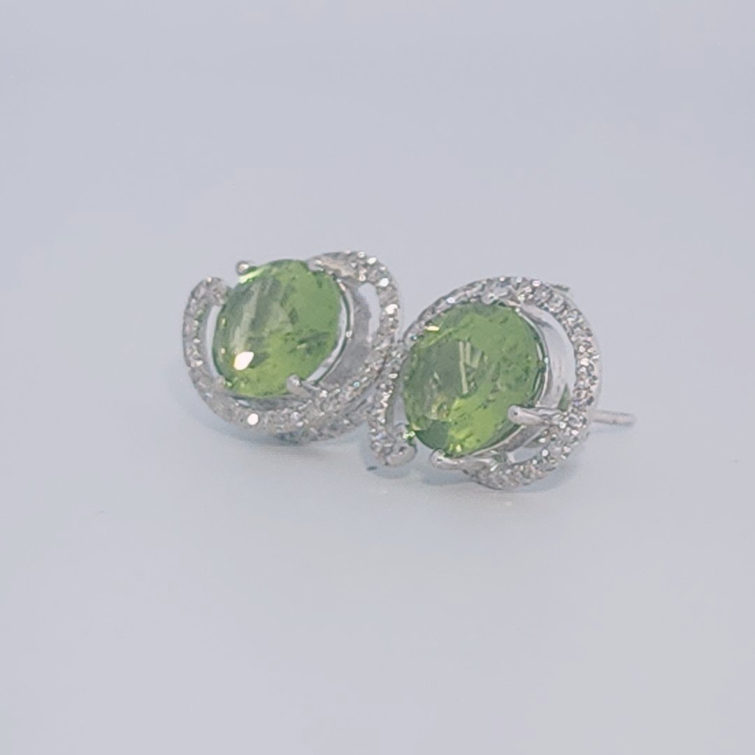 18K White Gold Earrings, set with 2 Oval Peridots (5ct total, Green, Loupe Clean) and Diamonds.