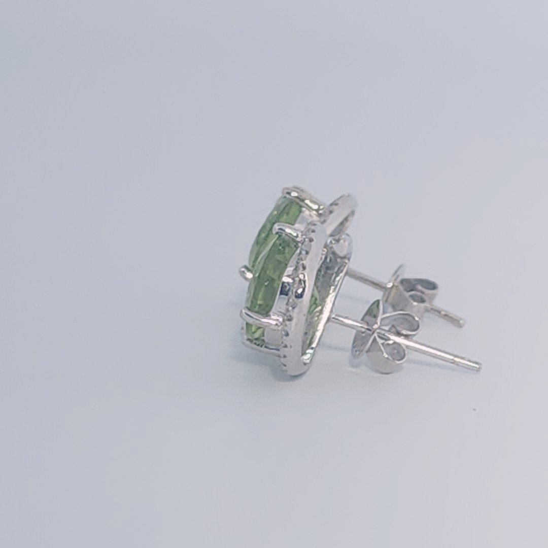 18K White Gold Earrings, set with 2 Oval Peridots (5ct total, Green, Loupe Clean) and Diamonds.