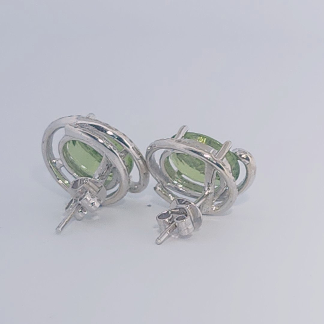 18K White Gold Earrings, set with 2 Oval Peridots (5ct total, Green, Loupe Clean) and Diamonds.