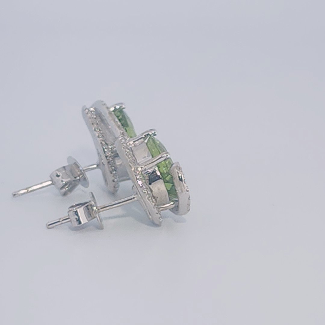 18K White Gold Earrings, set with 2 Oval Peridots (5ct total, Green, Loupe Clean) and Diamonds.