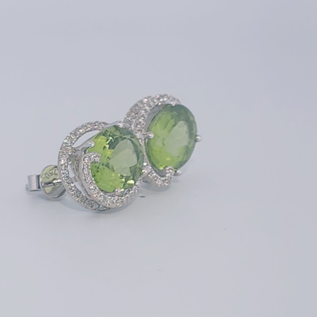 18K White Gold Earrings, set with 2 Oval Peridots (5ct total, Green, Loupe Clean) and Diamonds.