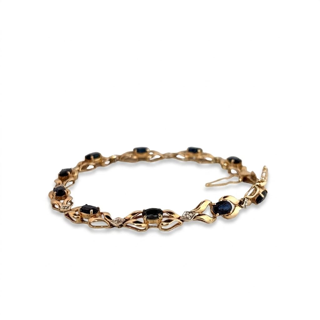 14K Yellow Gold Bracelet, set with 10 Oval Blue Sapphires and 9 Brilliant Cut Diamonds.