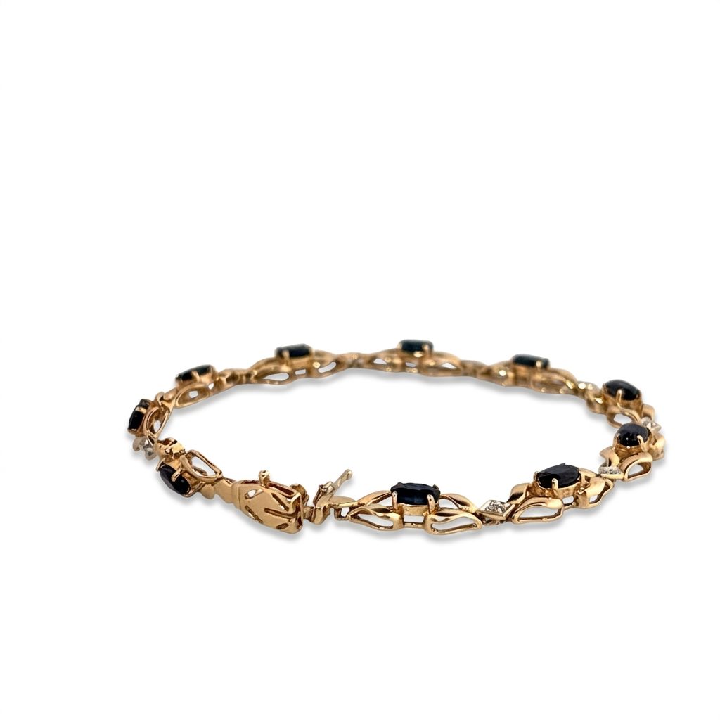 14K Yellow Gold Bracelet, set with 10 Oval Blue Sapphires and 9 Brilliant Cut Diamonds.
