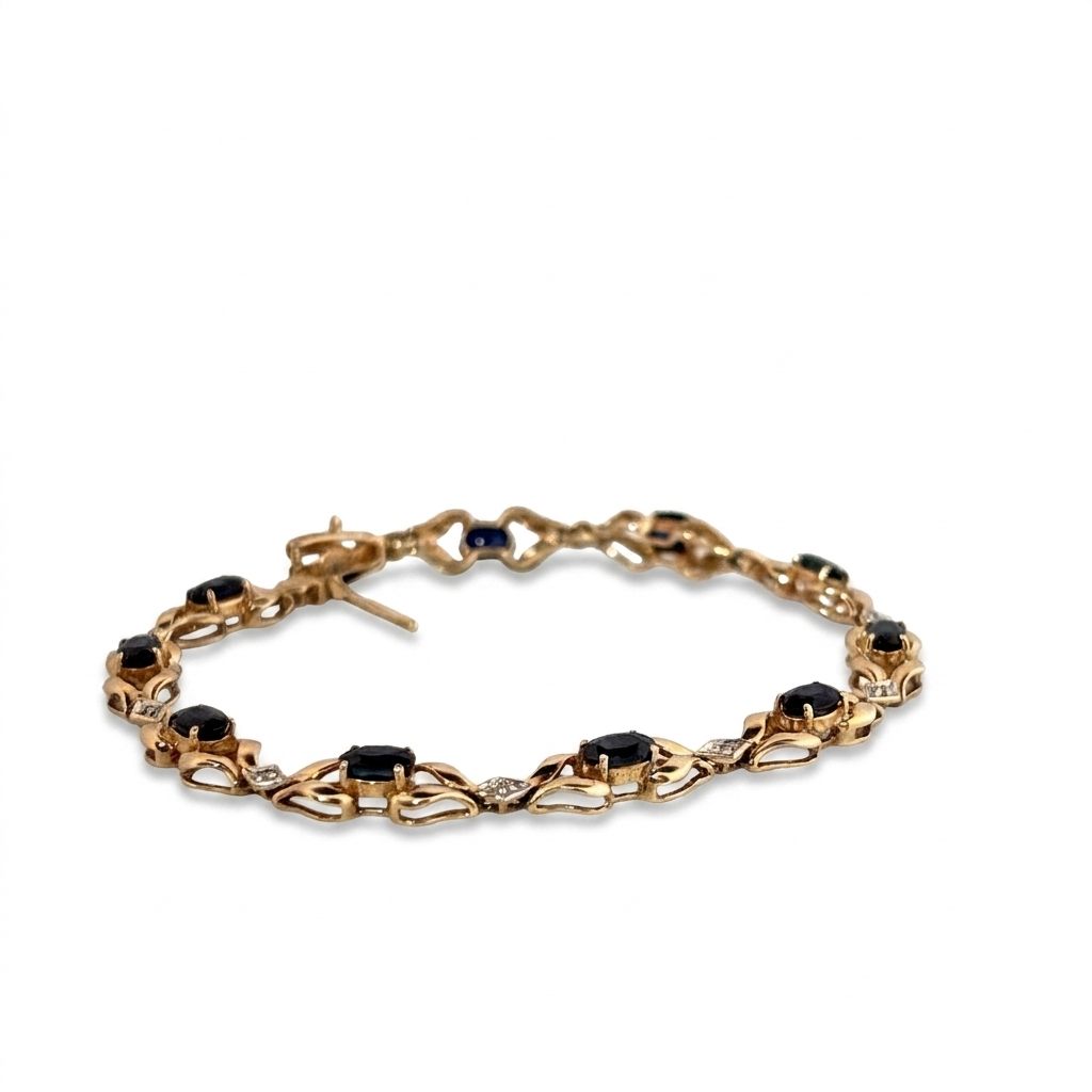 14K Yellow Gold Bracelet, set with 10 Oval Blue Sapphires and 9 Brilliant Cut Diamonds.