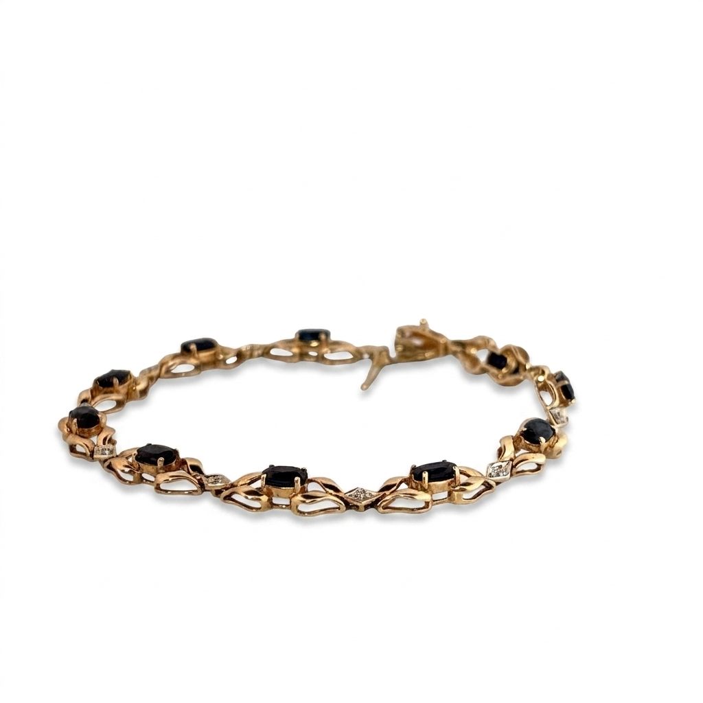 14K Yellow Gold Bracelet, set with 10 Oval Blue Sapphires and 9 Brilliant Cut Diamonds.