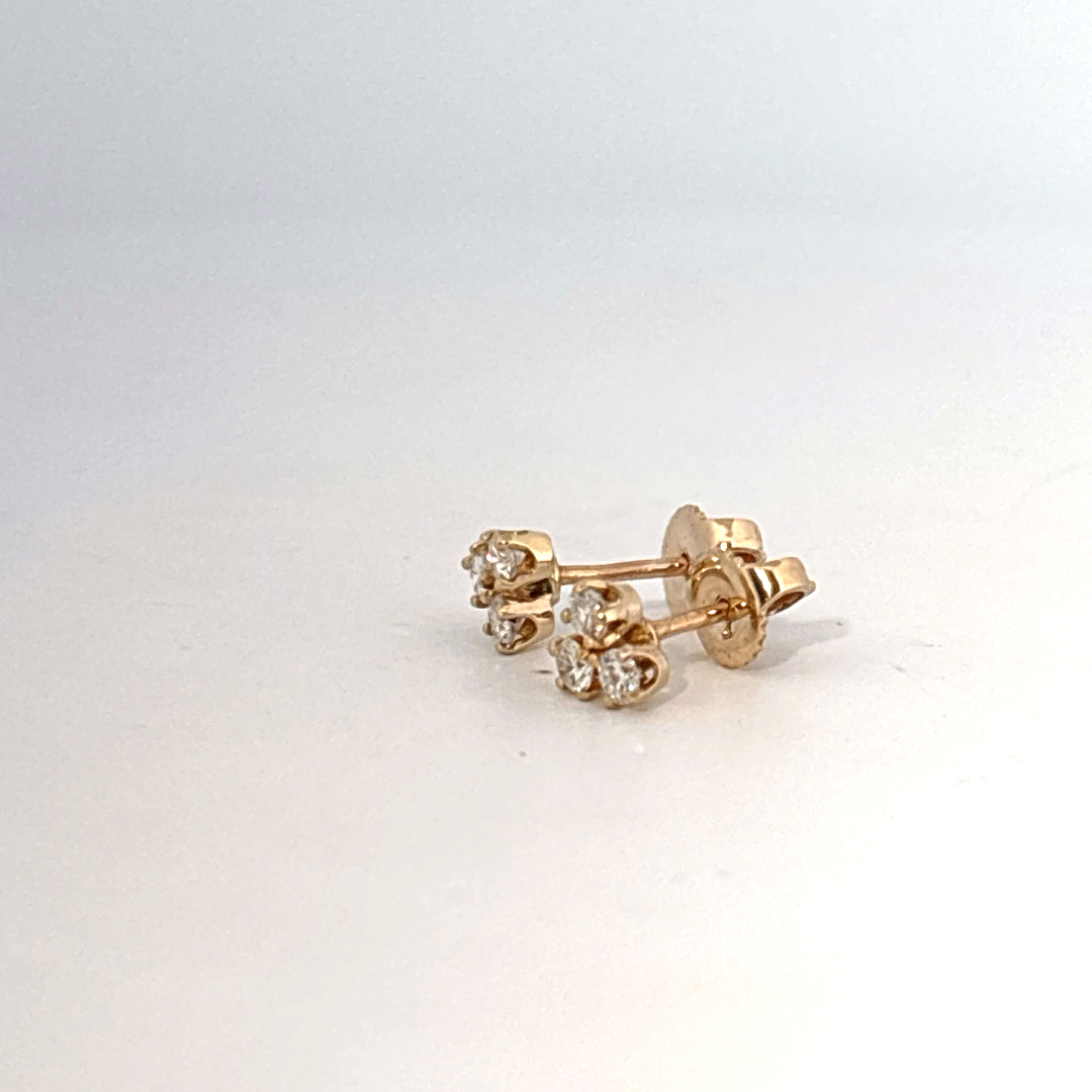14K Yellow Gold Earrings set with 6 Round Brilliant Cut Diamonds totaling 0.18ct, E color.
