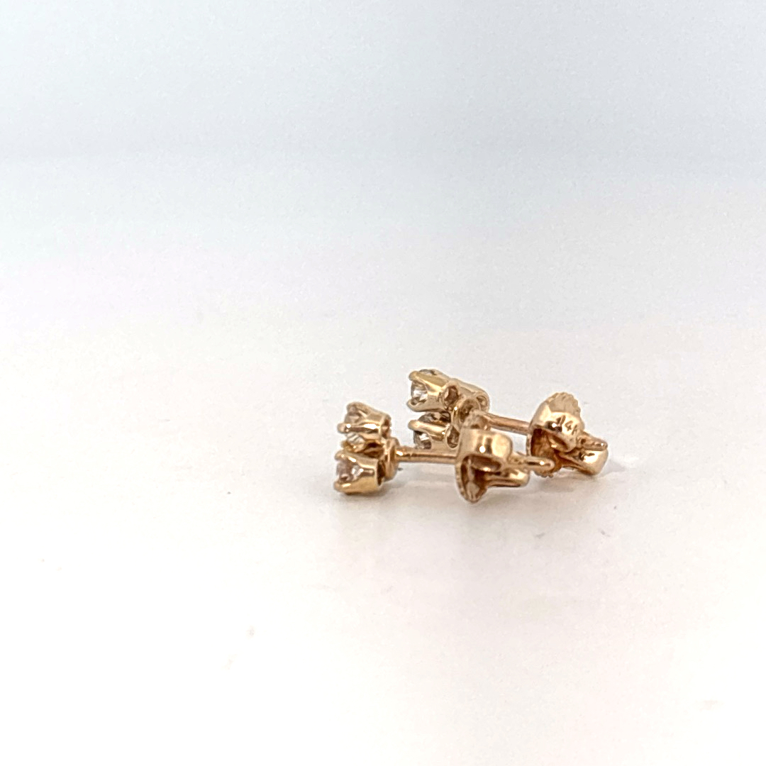 14K Yellow Gold Earrings set with 6 Round Brilliant Cut Diamonds totaling 0.18ct, E color.
