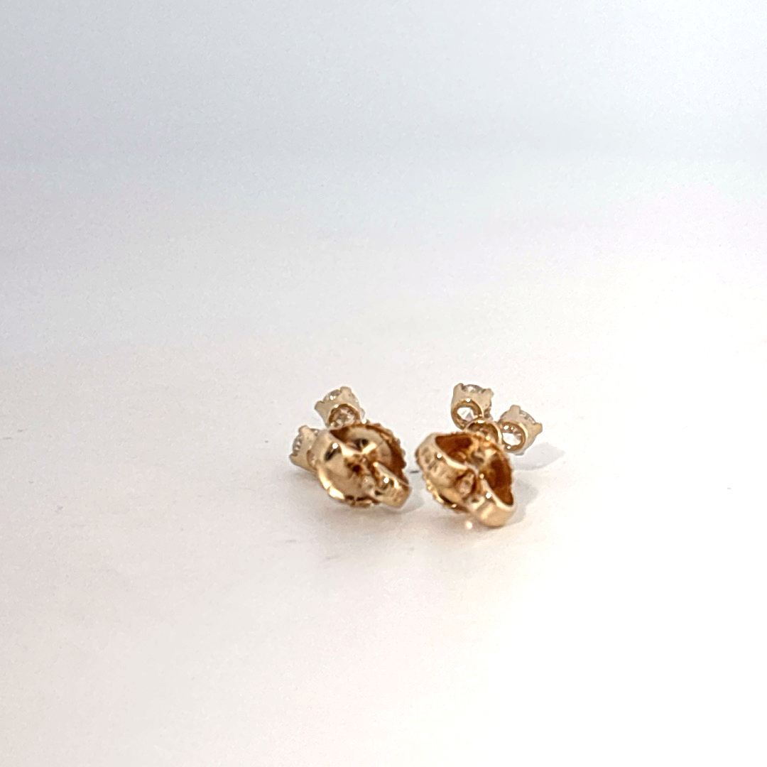 14K Yellow Gold Earrings set with 6 Round Brilliant Cut Diamonds totaling 0.18ct, E color.