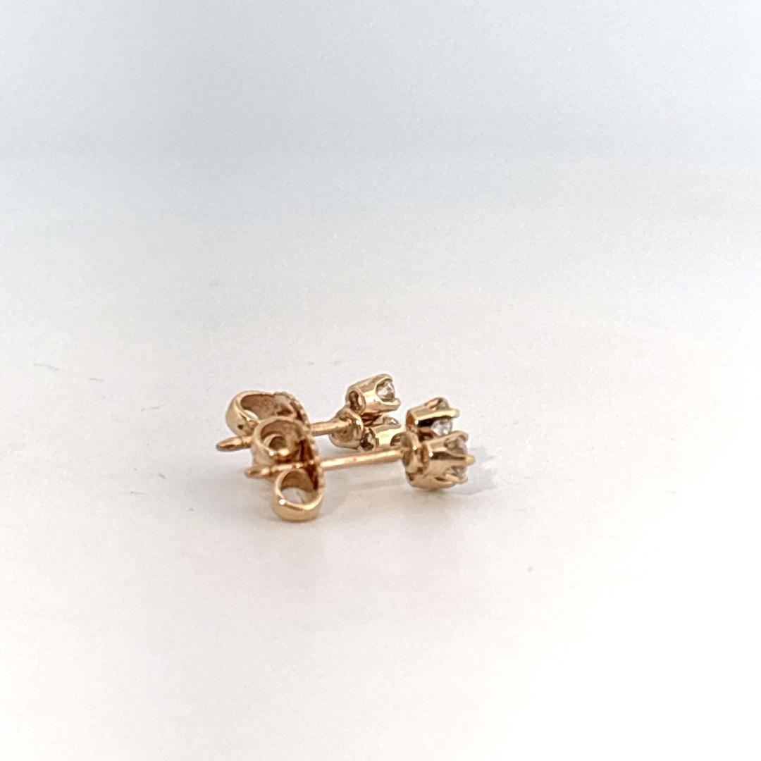 14K Yellow Gold Earrings set with 6 Round Brilliant Cut Diamonds totaling 0.18ct, E color.