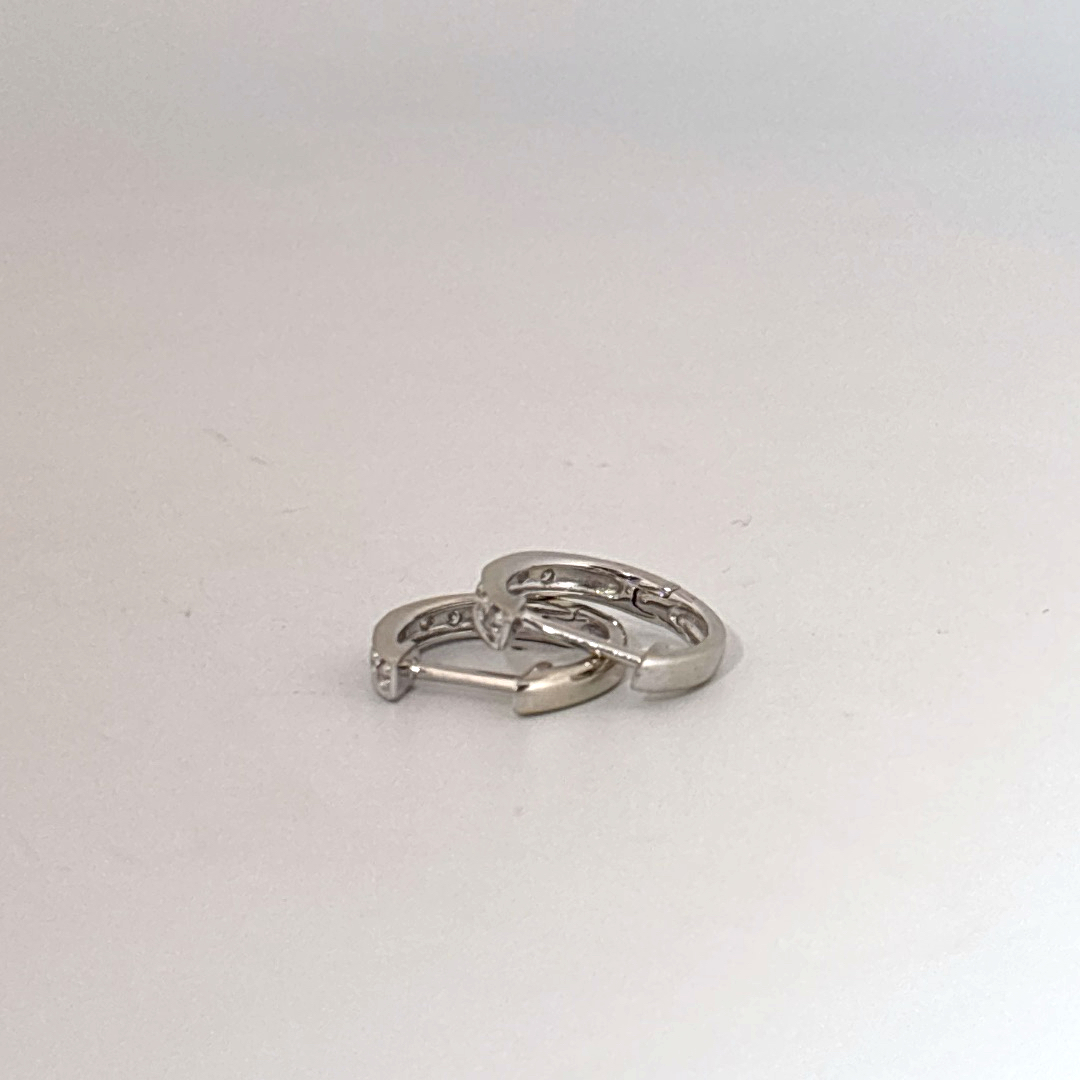 14K White Gold Diamond Hoop Earrings, female style, channel-set diamonds.