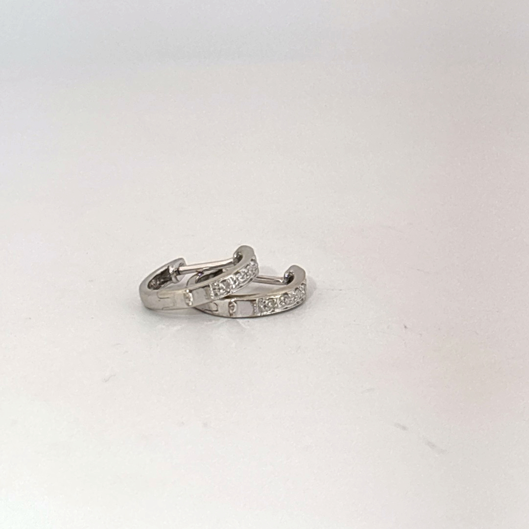 14K White Gold Diamond Hoop Earrings, female style, channel-set diamonds.