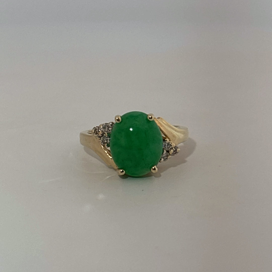 14K Yellow Gold Ring, set with 1 Oval Green Jade Cabochon and 6 White Diamonds on the shoulders, female style.