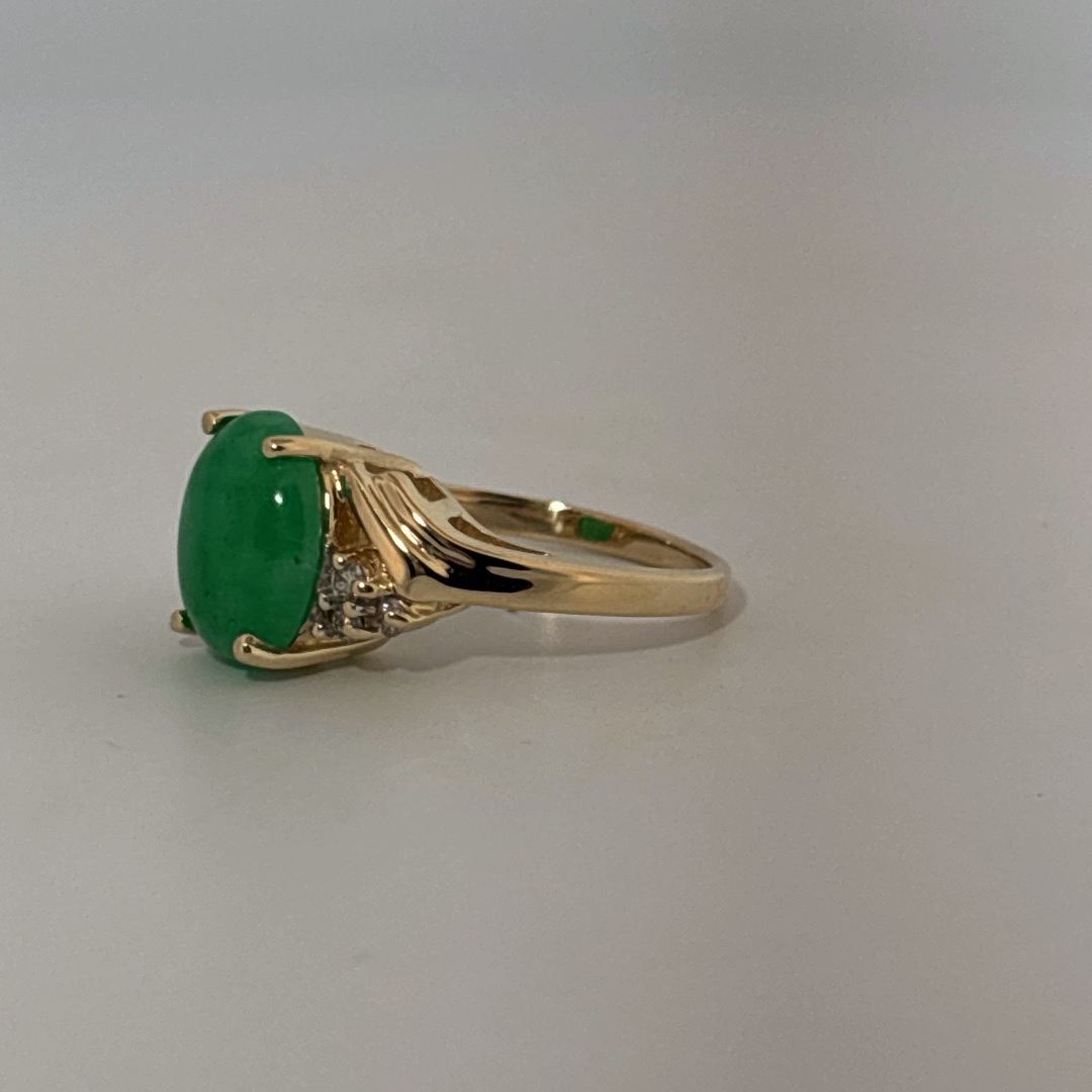 14K Yellow Gold Ring, set with 1 Oval Green Jade Cabochon and 6 White Diamonds on the shoulders, female style.
