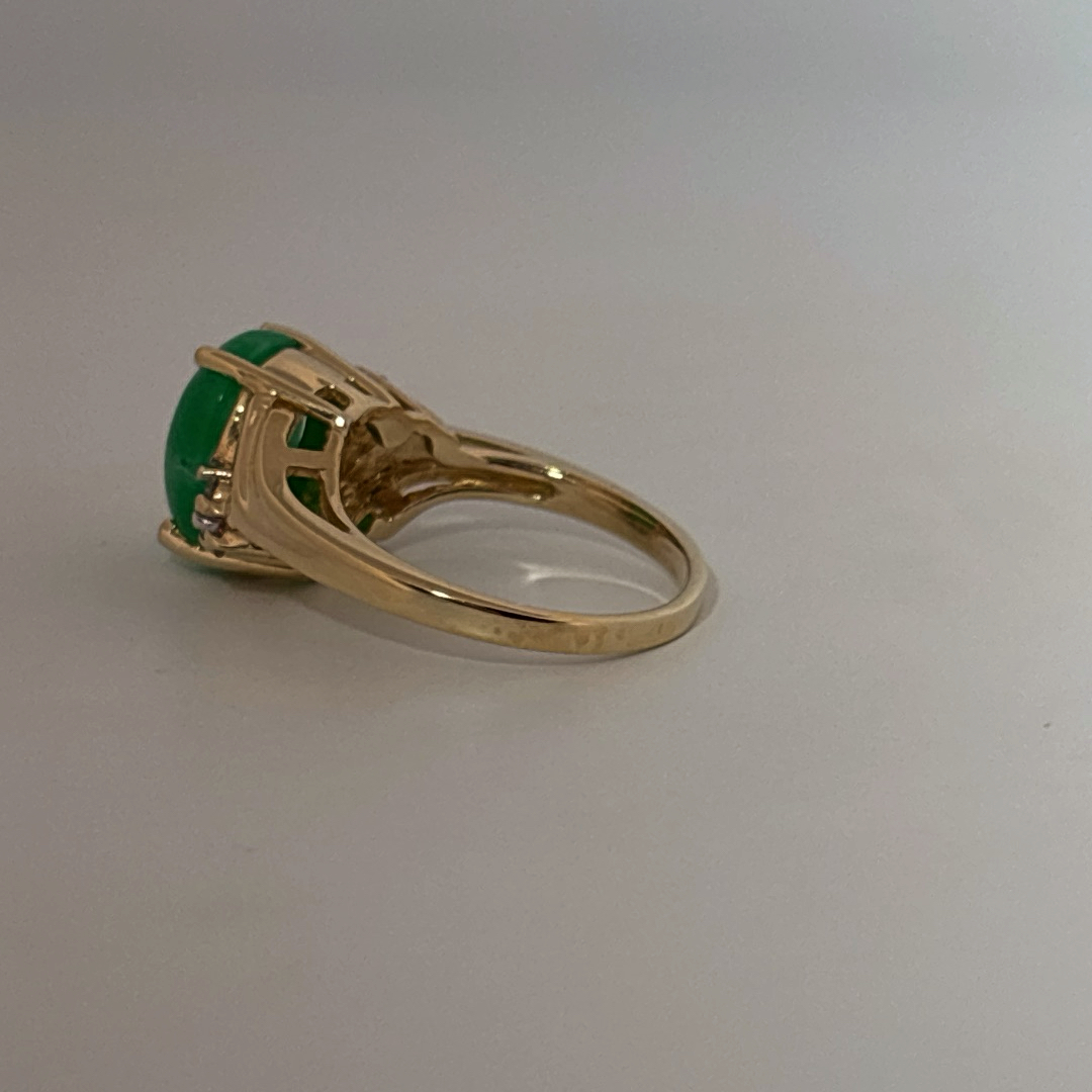 14K Yellow Gold Ring, set with 1 Oval Green Jade Cabochon and 6 White Diamonds on the shoulders, female style.
