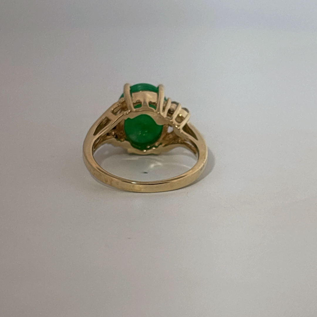 14K Yellow Gold Ring, set with 1 Oval Green Jade Cabochon and 6 White Diamonds on the shoulders, female style.