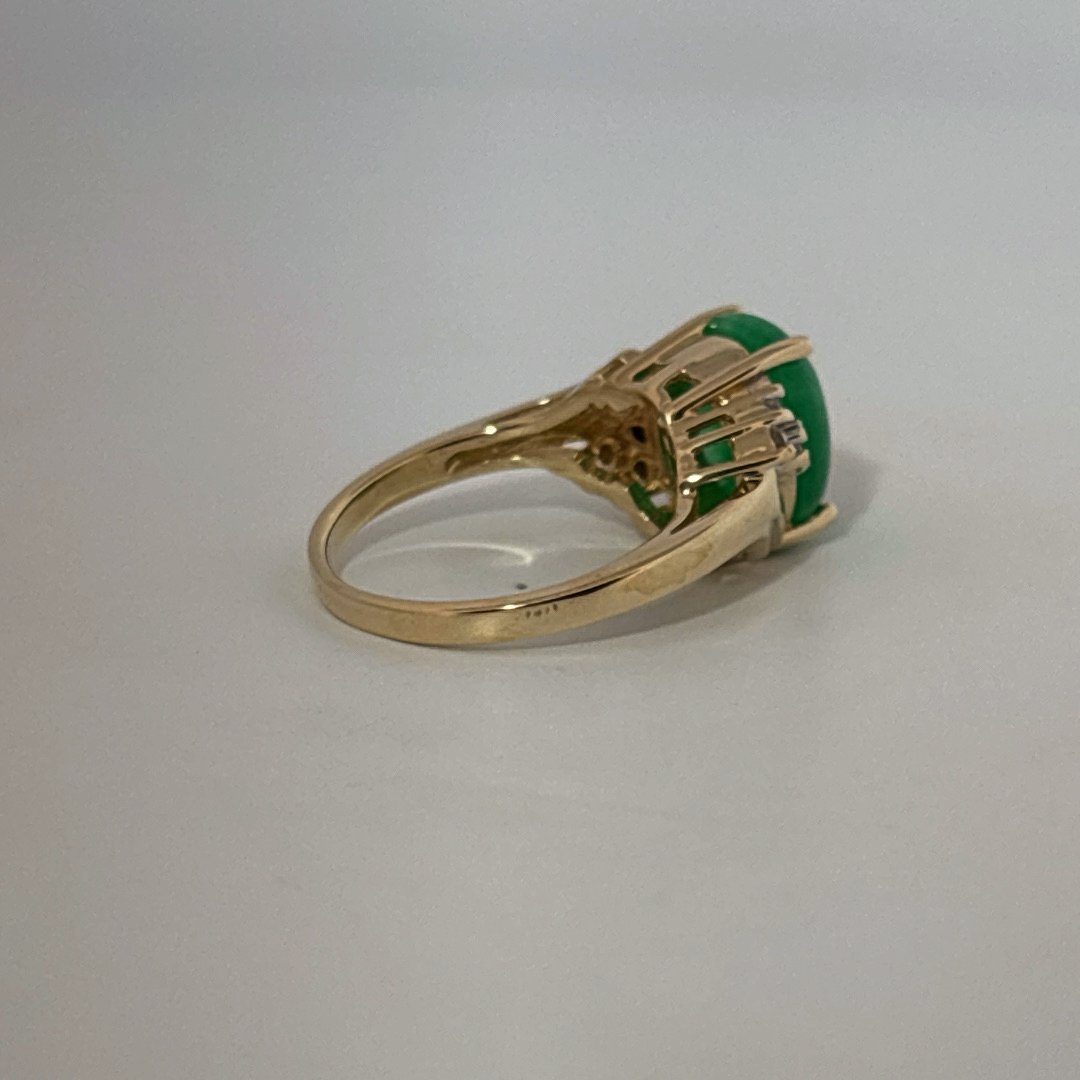 14K Yellow Gold Ring, set with 1 Oval Green Jade Cabochon and 6 White Diamonds on the shoulders, female style.