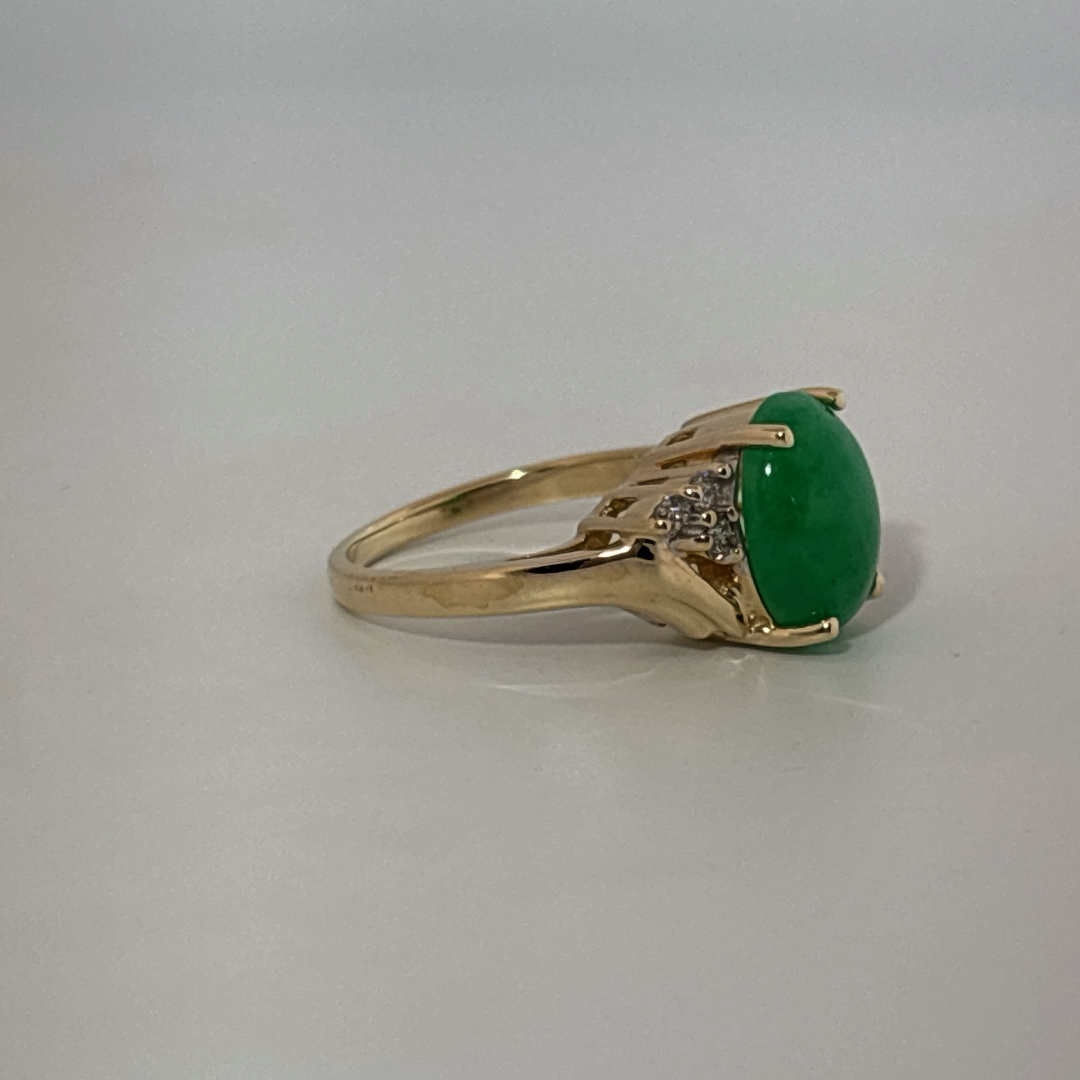 14K Yellow Gold Ring, set with 1 Oval Green Jade Cabochon and 6 White Diamonds on the shoulders, female style.