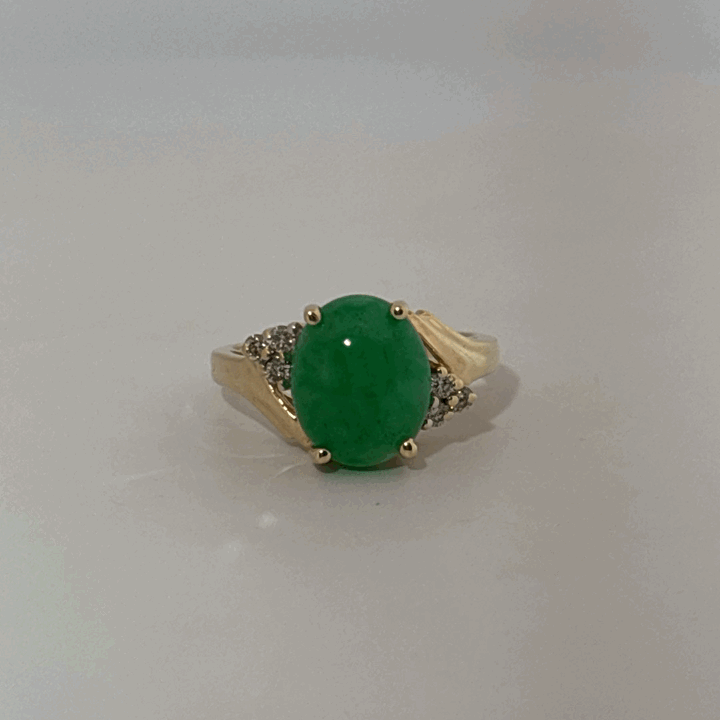 14K Yellow Gold Ring, set with 1 Oval Green Jade Cabochon and 6 White Diamonds on the shoulders, female style.