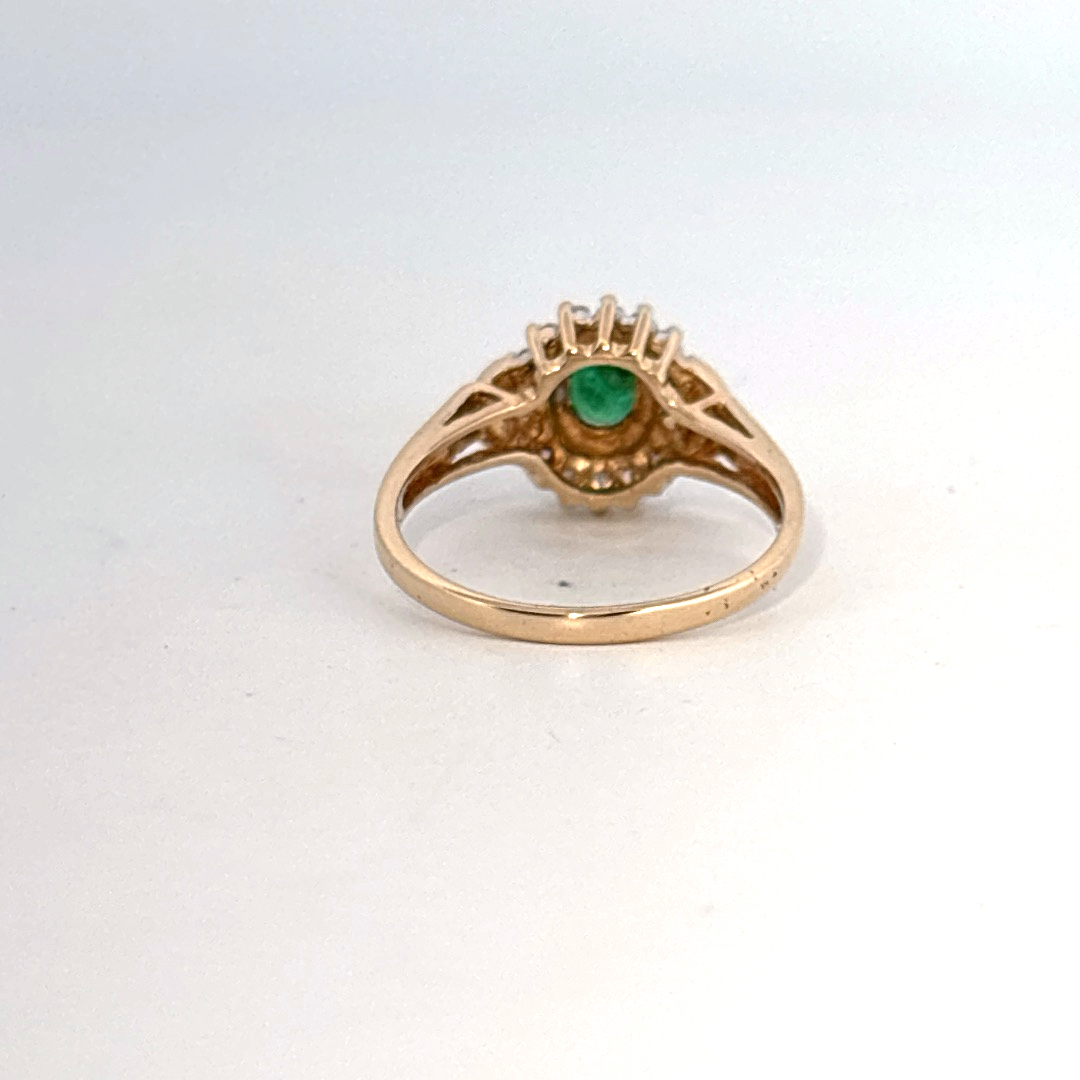 14K Yellow Gold Ring, set with 1 Oval Emerald and surrounding Round Diamonds, women's style.