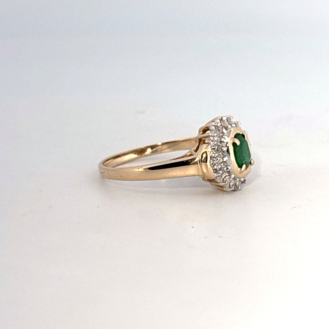14K Yellow Gold Ring, set with 1 Oval Emerald and surrounding Round Diamonds, women's style.