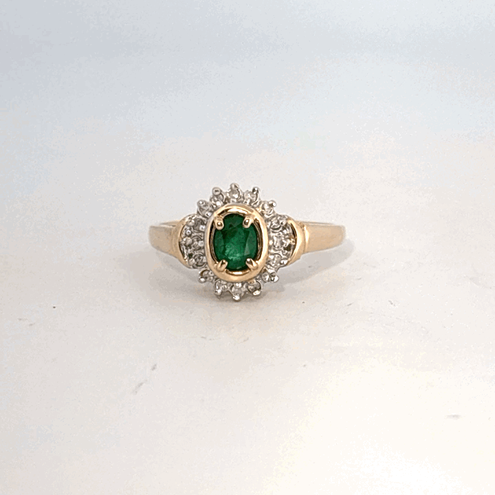 14K Yellow Gold Ring, set with 1 Oval Emerald and surrounding Round Diamonds, women's style.