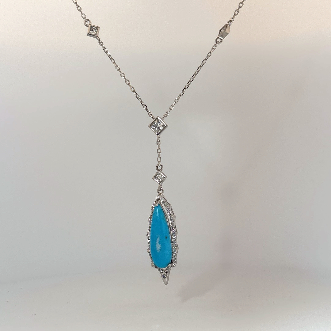 Sterling Silver Necklace set with 1 Turquoise stone and multiple small clear stones.