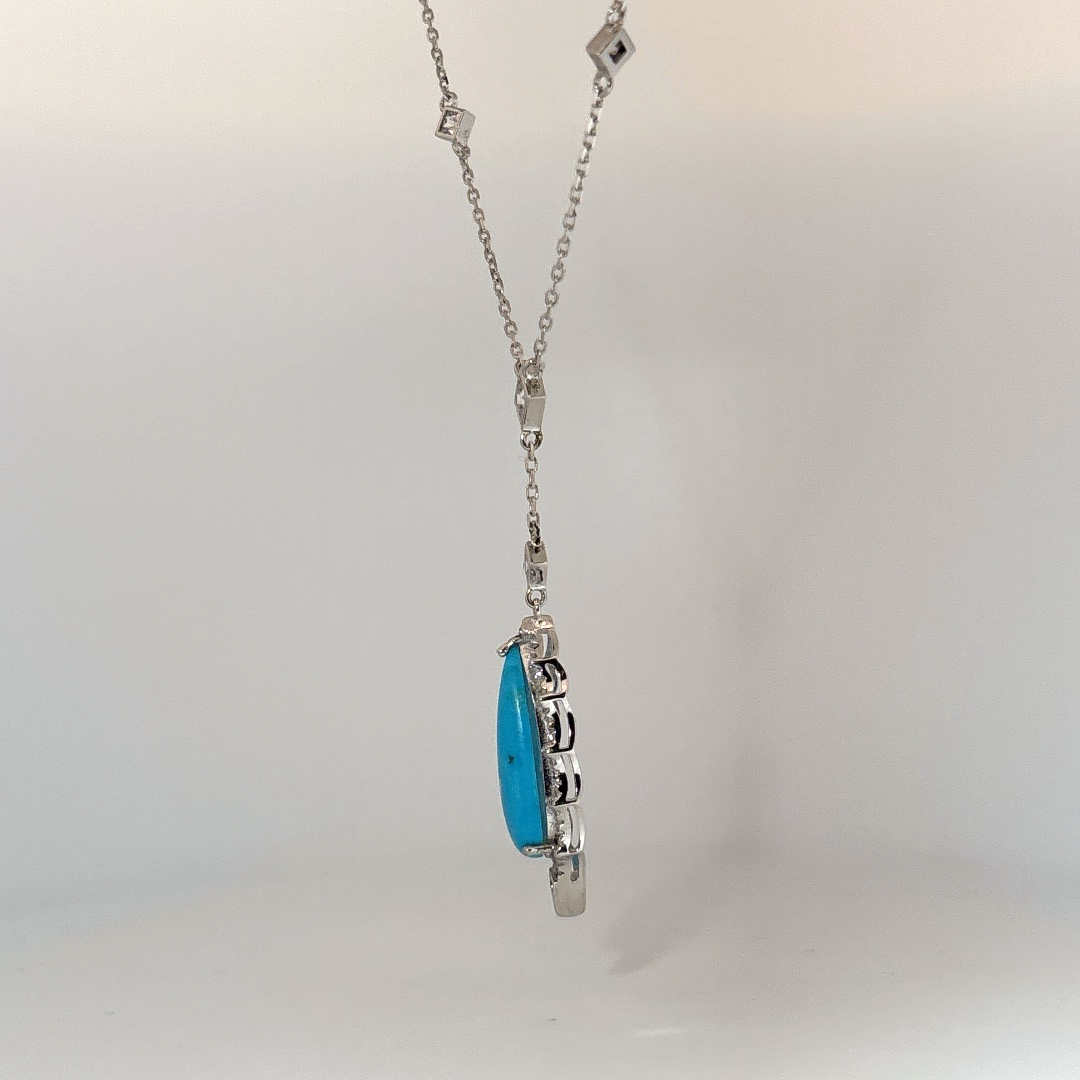 Sterling Silver Necklace set with 1 Turquoise stone and multiple small clear stones.