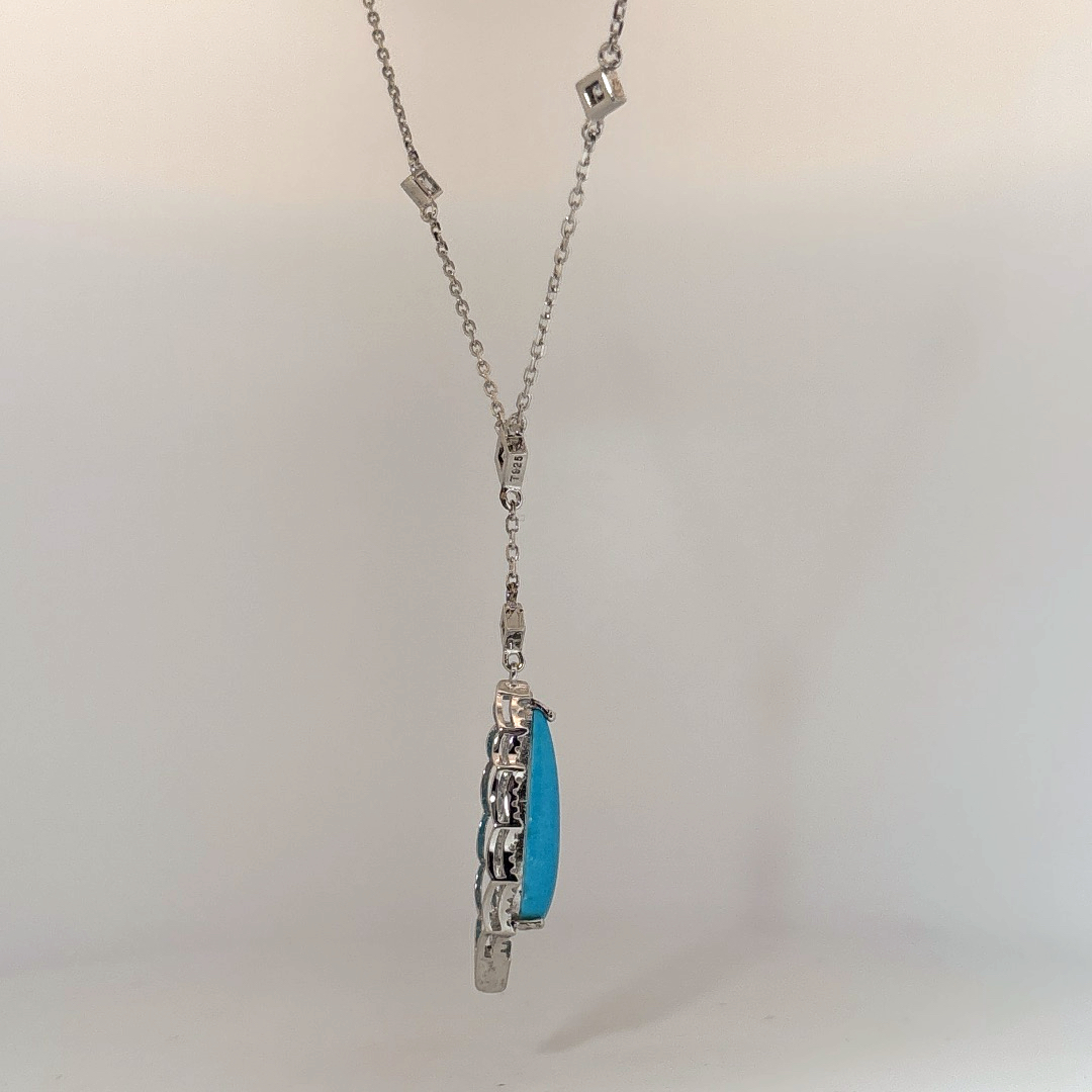 Sterling Silver Necklace set with 1 Turquoise stone and multiple small clear stones.