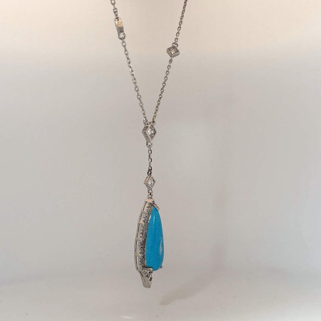 Sterling Silver Necklace set with 1 Turquoise stone and multiple small clear stones.