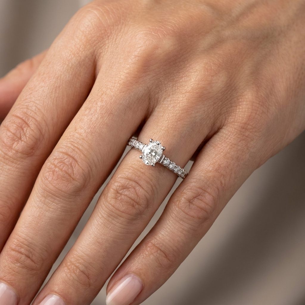 14K White Gold Engagement Ring, set with 1 Oval Diamond (0.52ct, E, SI) and 12 Round Diamonds (total 0.25ct)